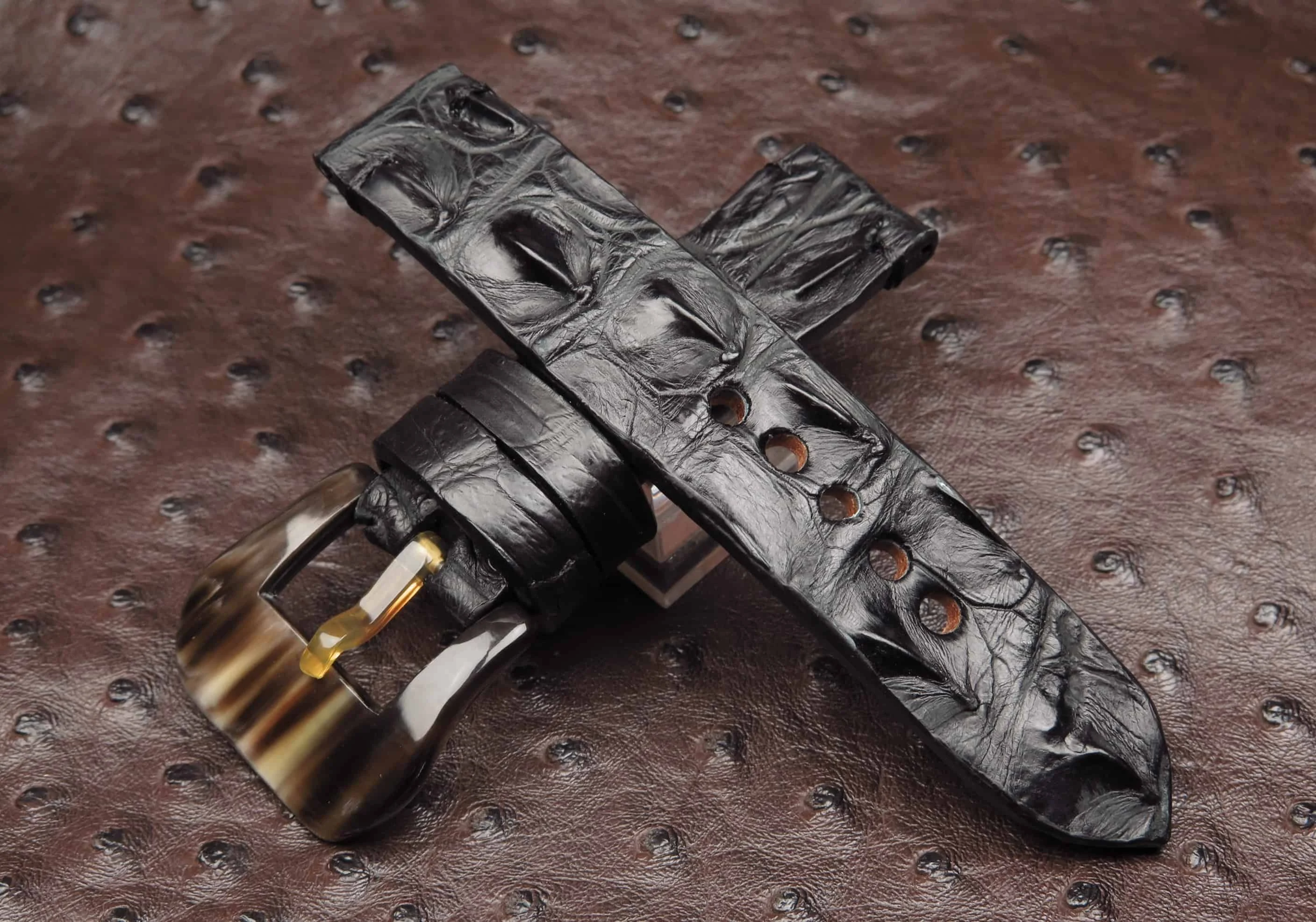 Black crocodile hornback strap with a bronze buckle