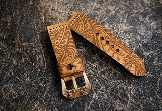 Handmade leather straps arranged with a wristwatch