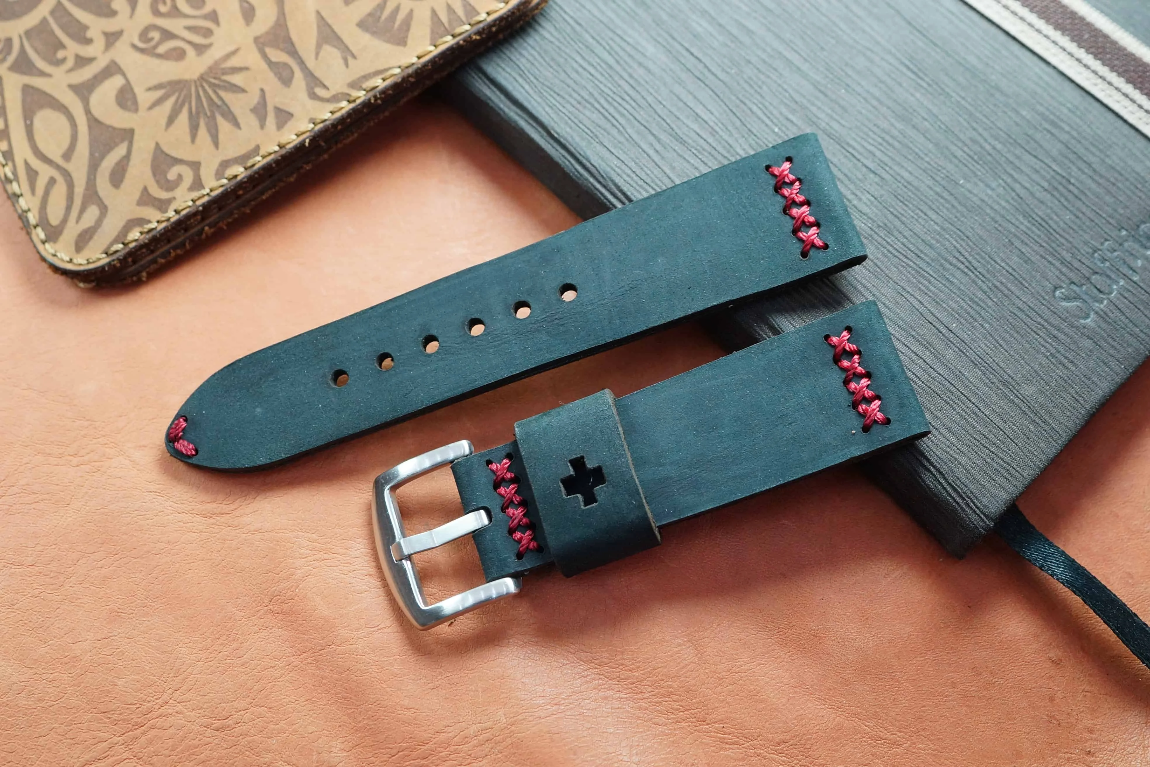 Handmade teal leather strap with contrast stitching and a steel buckle